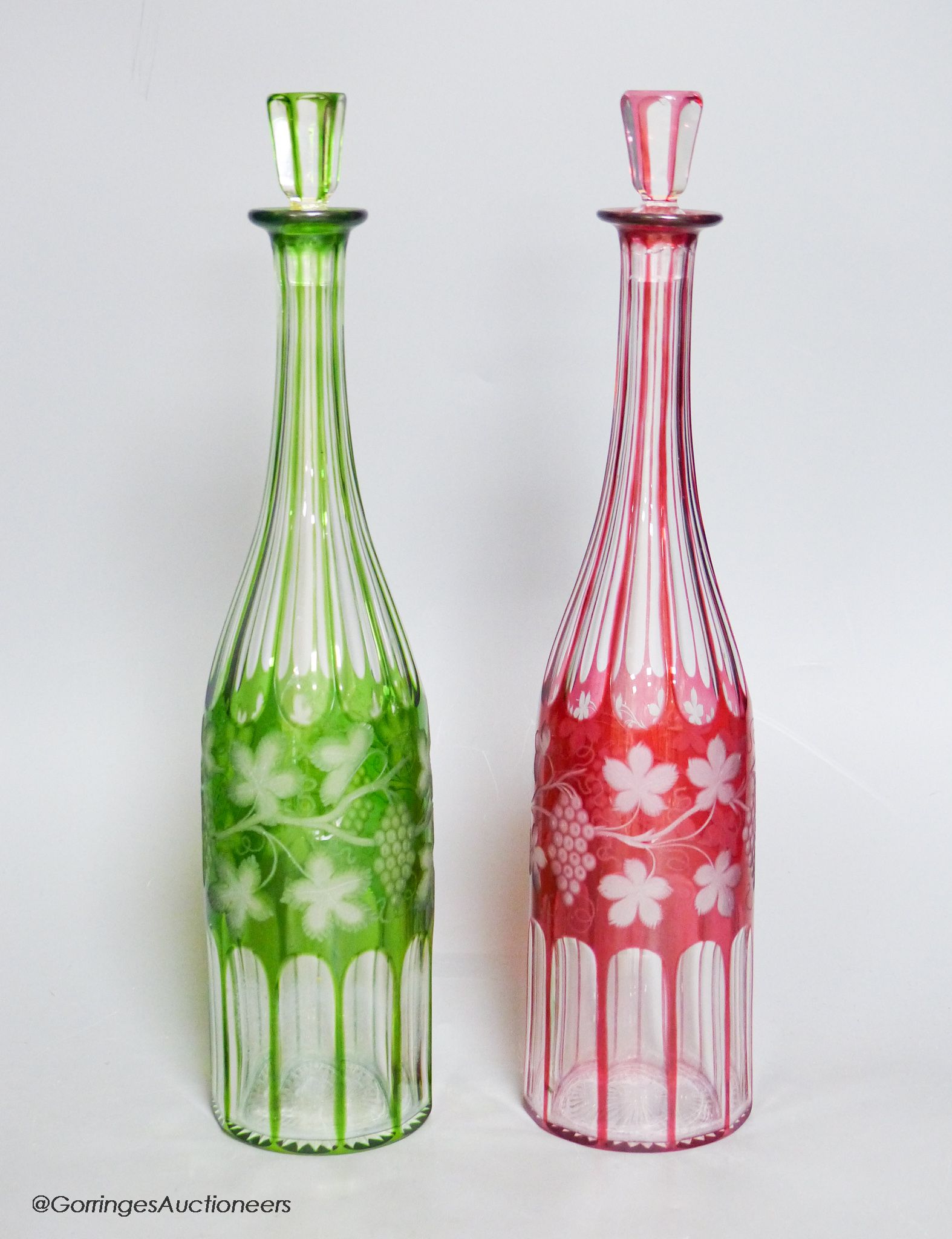 A pair of Bohemian colour flashed glass decanters
